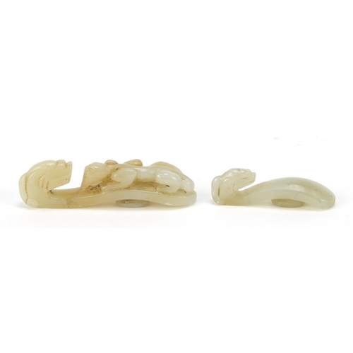 81 - Two Chinese white jade belt hooks carved with dragons, the largest 6.2cm in length