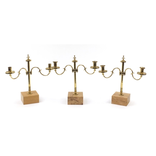 49 - Three pairs of early 19th century three branch brass altar candelabras with turned columns, each rai... 