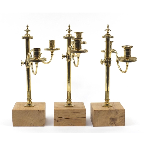 49 - Three pairs of early 19th century three branch brass altar candelabras with turned columns, each rai... 