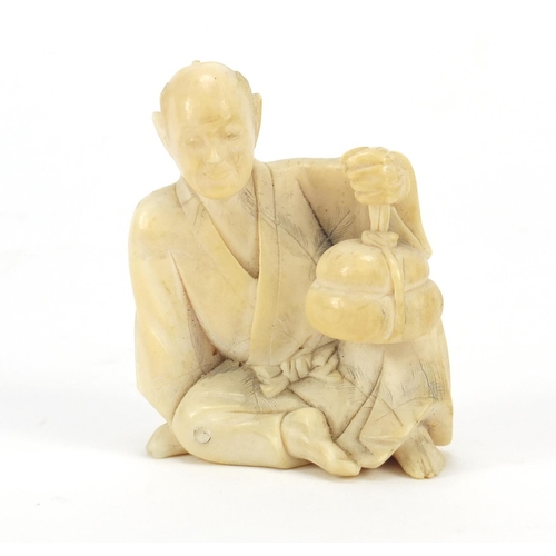 175 - Japanese carved ivory Okimono of a figure holding a basket, 6cm high