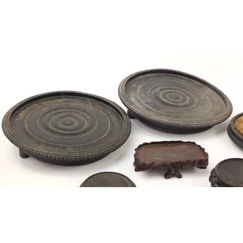 173 - Chinese carved soapstone figure of an Elder and collection of Chinese carved hardwood stands, each 3... 