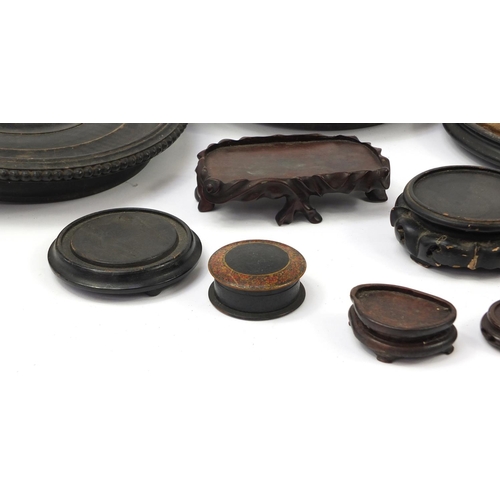 173 - Chinese carved soapstone figure of an Elder and collection of Chinese carved hardwood stands, each 3... 