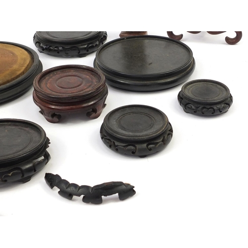 173 - Chinese carved soapstone figure of an Elder and collection of Chinese carved hardwood stands, each 3... 