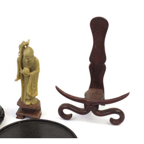 173 - Chinese carved soapstone figure of an Elder and collection of Chinese carved hardwood stands, each 3... 