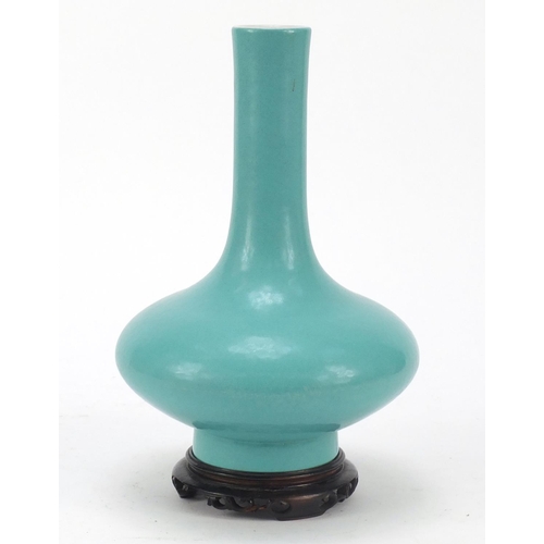 79 - Chinese porcelain vase having a turquoise glaze, raised on carved hardwood stand, six figure Qianlon... 