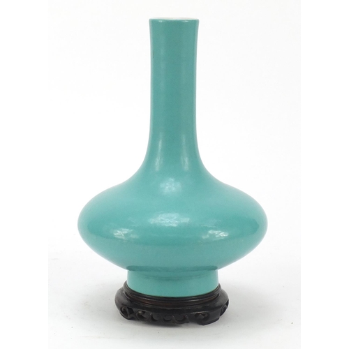 79 - Chinese porcelain vase having a turquoise glaze, raised on carved hardwood stand, six figure Qianlon... 