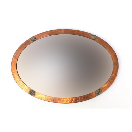 7 - Arts & Crafts oval copper wall mirror with bevelled glass, 83cm x 58cm