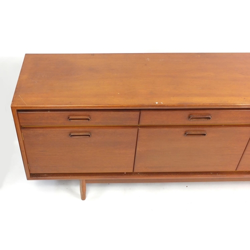 845 - 1970's sideboard fitted with four drawers above four cupboard doors, 233.5cm W x 78cm H x 46cm D