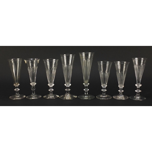141 - Eight 18th/19th century Champagne flutes with blade collars and knopped stems, the largest 18cm high