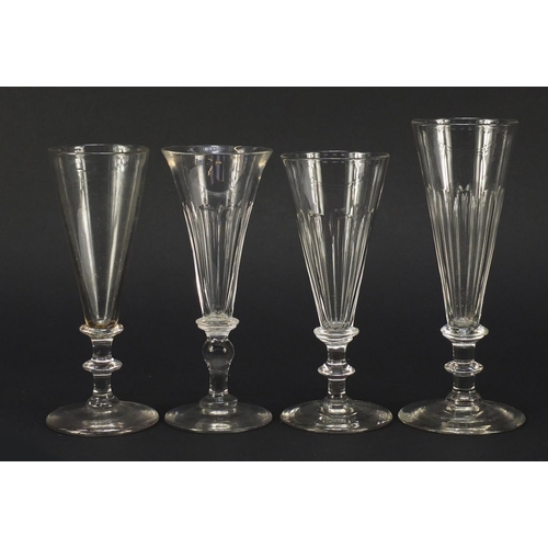 141 - Eight 18th/19th century Champagne flutes with blade collars and knopped stems, the largest 18cm high