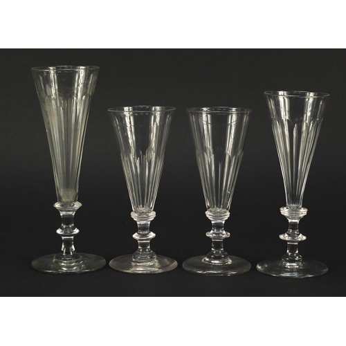 141 - Eight 18th/19th century Champagne flutes with blade collars and knopped stems, the largest 18cm high
