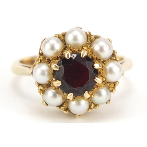 566 - Unmarked gold garnet and pearl ring, size I, 4.5g