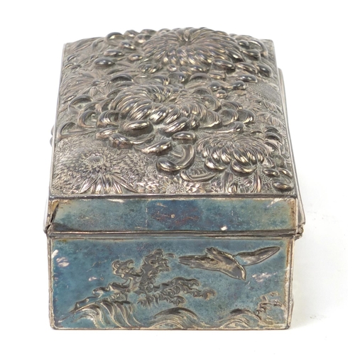 85 - Japanese silver coloured metal casket embossed with flowers, birds and waves, 17cm x 9cm x 5.5cm