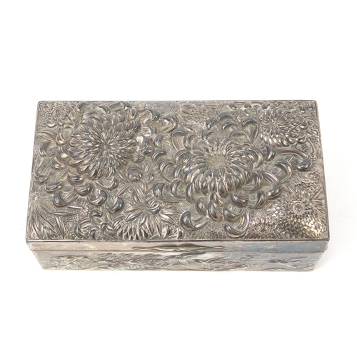 85 - Japanese silver coloured metal casket embossed with flowers, birds and waves, 17cm x 9cm x 5.5cm
