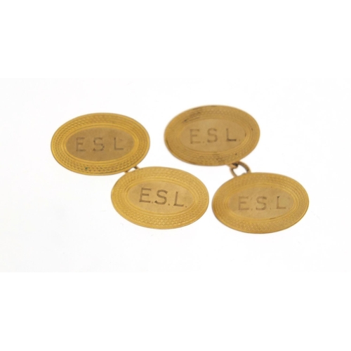 573 - Pair of 9ct gold cufflinks with engine turned decoration, 1.7cm in length, 4.4g