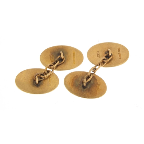 573 - Pair of 9ct gold cufflinks with engine turned decoration, 1.7cm in length, 4.4g