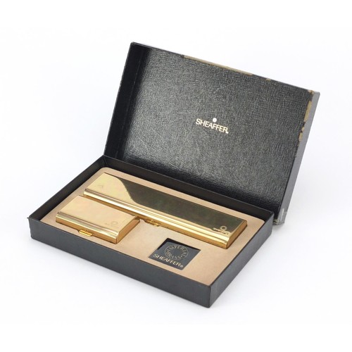 1984 - Sheaffer brass fountain pen and ballpoint pen set, with box, the fountain pen with 14K gold nib