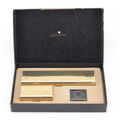 1984 - Sheaffer brass fountain pen and ballpoint pen set, with box, the fountain pen with 14K gold nib