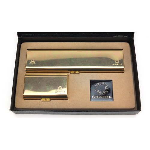 1984 - Sheaffer brass fountain pen and ballpoint pen set, with box, the fountain pen with 14K gold nib