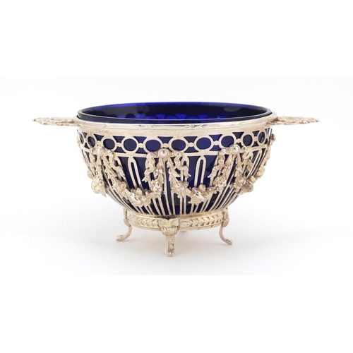 138 - Swedish 830 silver twin handle pedestal bowl with blue glass liner, cast and pierced with bows and s... 