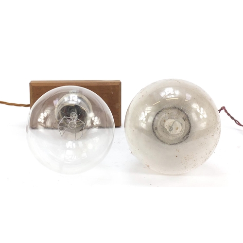 272 - Two large Industrial style bulbs, one on a gimbal support, the other mounted on a wooden block, the ... 