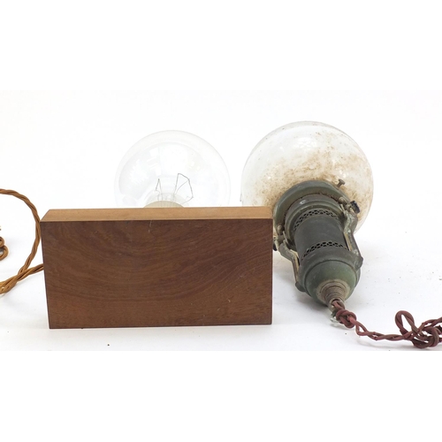 272 - Two large Industrial style bulbs, one on a gimbal support, the other mounted on a wooden block, the ... 