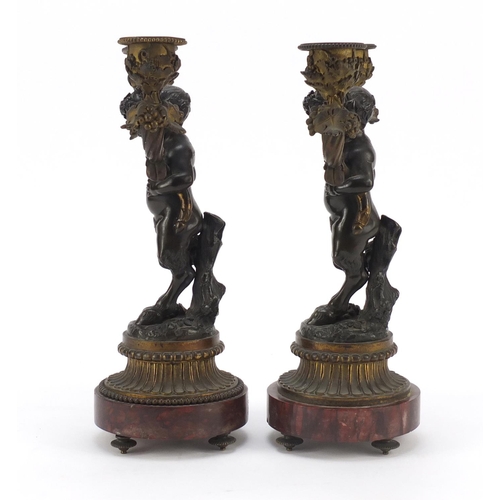 322 - After Claude Michel Clodion, pair of 19th century patinated bronze figural two branch candlesticks w... 