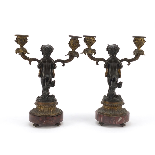 322 - After Claude Michel Clodion, pair of 19th century patinated bronze figural two branch candlesticks w... 