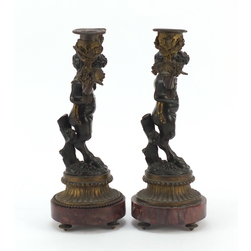 322 - After Claude Michel Clodion, pair of 19th century patinated bronze figural two branch candlesticks w... 