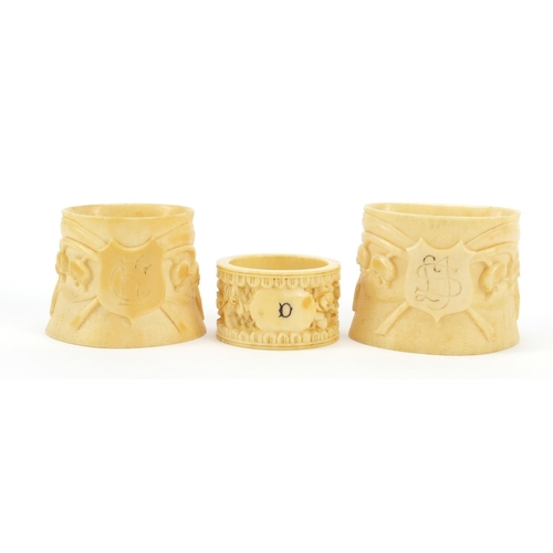 2004 - Three ivory napkin rings carved with flowers, the largest 5.3cm high