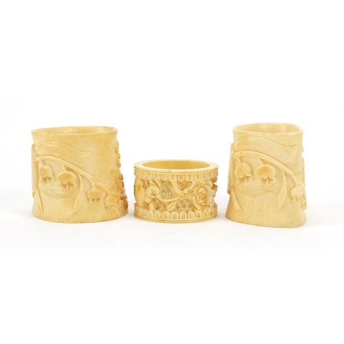 2004 - Three ivory napkin rings carved with flowers, the largest 5.3cm high