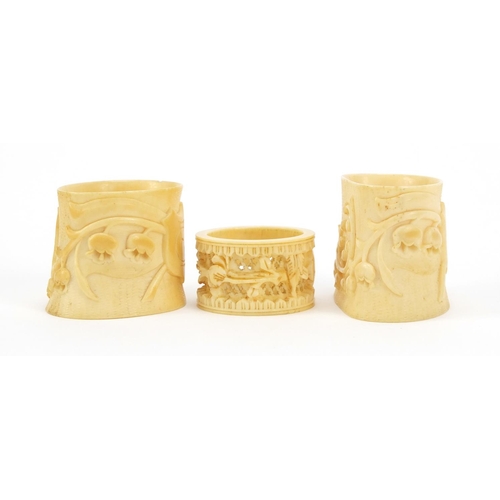 2004 - Three ivory napkin rings carved with flowers, the largest 5.3cm high