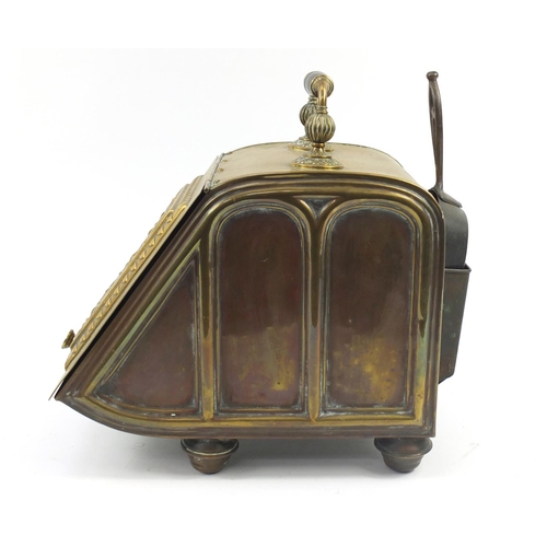 144 - Victorian aesthetic brass coal box with iron shovel, the sloping hinged front with circular floral m... 