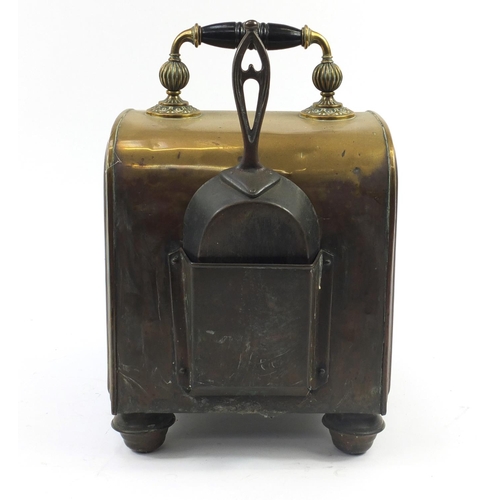 144 - Victorian aesthetic brass coal box with iron shovel, the sloping hinged front with circular floral m... 