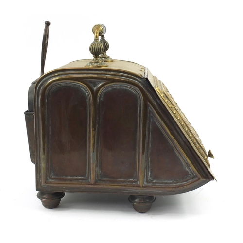 144 - Victorian aesthetic brass coal box with iron shovel, the sloping hinged front with circular floral m... 