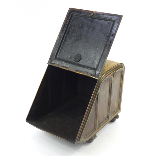 144 - Victorian aesthetic brass coal box with iron shovel, the sloping hinged front with circular floral m... 