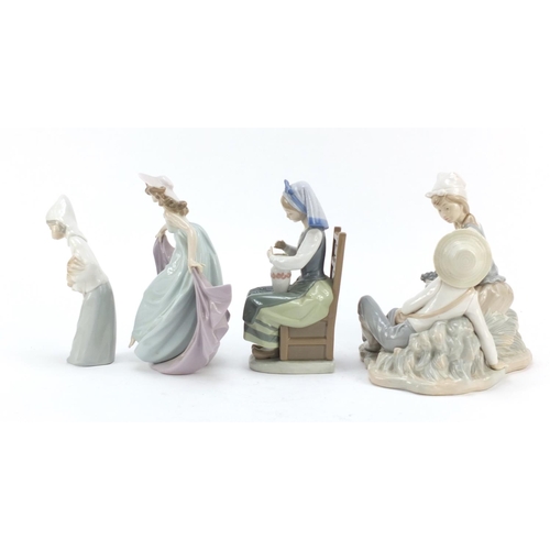 487 - Four Lladro and Nao figure groups, the largest 23cm high