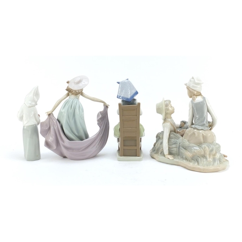 487 - Four Lladro and Nao figure groups, the largest 23cm high