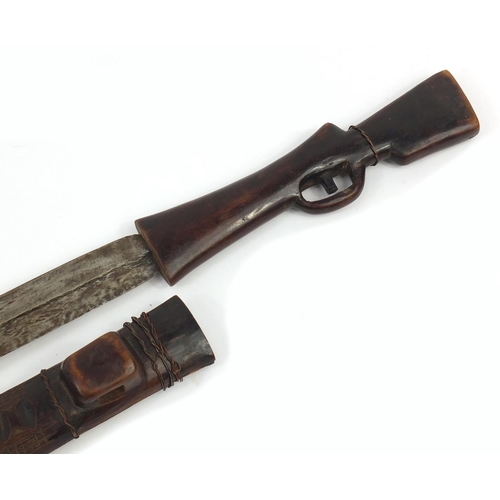 900 - African carved wood sword in the form of a rifle with steel blade, 71cm in length