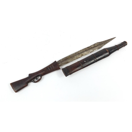 900 - African carved wood sword in the form of a rifle with steel blade, 71cm in length