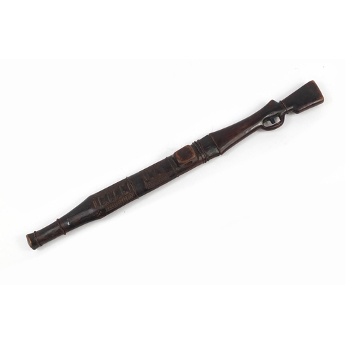 900 - African carved wood sword in the form of a rifle with steel blade, 71cm in length