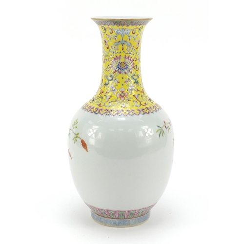 123 - Chinese porcelain bottle vase, hand painted in the famille rose palette with flowers and a garden sc... 