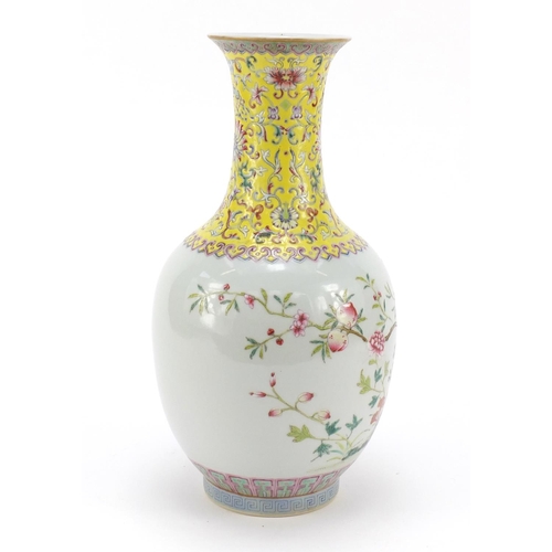 123 - Chinese porcelain bottle vase, hand painted in the famille rose palette with flowers and a garden sc... 