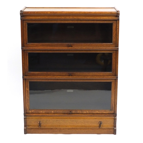 1313 - Oak Globe Wernicke three section bookcase with drawer to the base, 115.5cm H x 87cm W x 30.5cm D