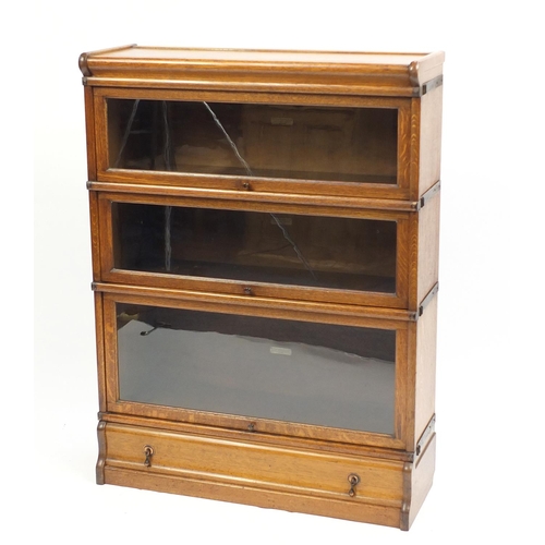 1313 - Oak Globe Wernicke three section bookcase with drawer to the base, 115.5cm H x 87cm W x 30.5cm D