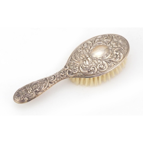 1987 - Silver backed clothes brush by WI Broadway & Co, embossed with face masks, birds and foliage, Birmin... 