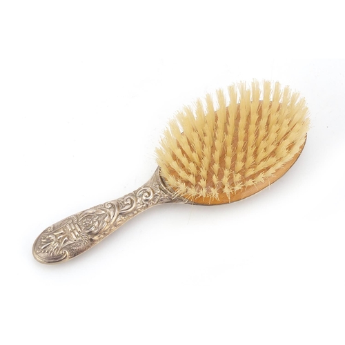 1987 - Silver backed clothes brush by WI Broadway & Co, embossed with face masks, birds and foliage, Birmin... 