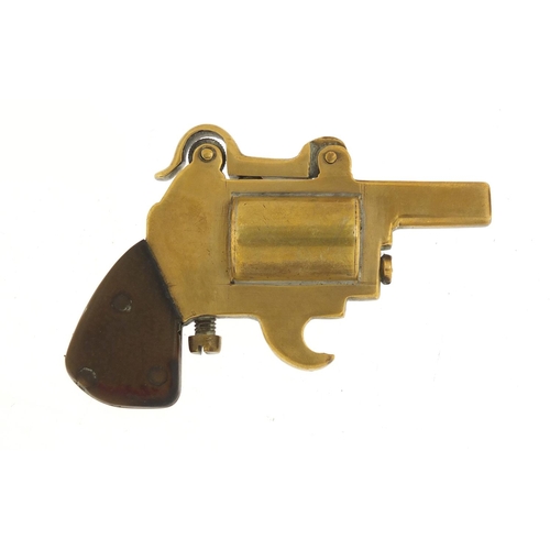 389 - Novelty brass lighter in the form of a pistol with bakelite grip, 8.5cm in length