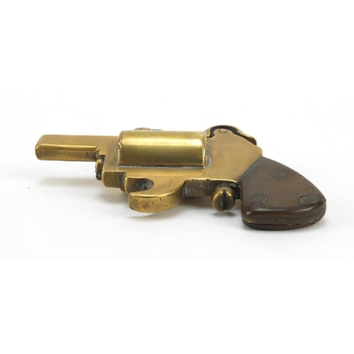 389 - Novelty brass lighter in the form of a pistol with bakelite grip, 8.5cm in length