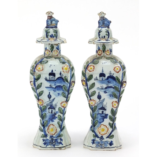 346 - **WITHDRAWN**Pair of Dutch Delft pottery vases and covers hand painted with village scenes, 21cm hig... 